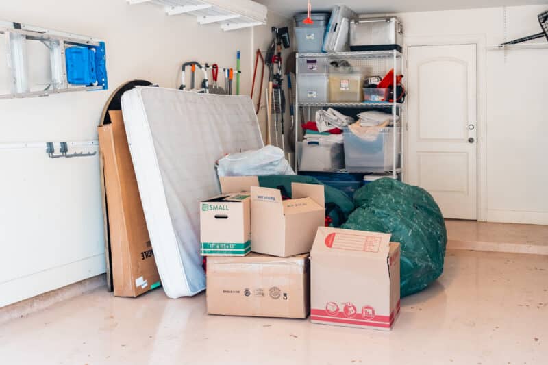 a san antonio garage with some junk and some organization shelves awaiting junk removal services from junkstart