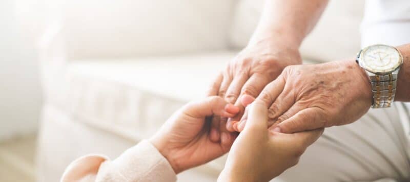 a pair of woman's hands holding another pair of hands