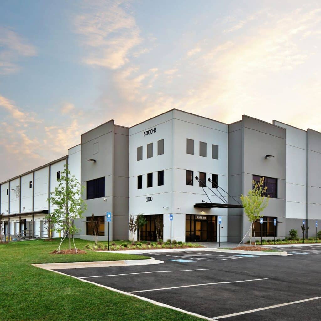 corner entrance of a large warehouse and parking lot