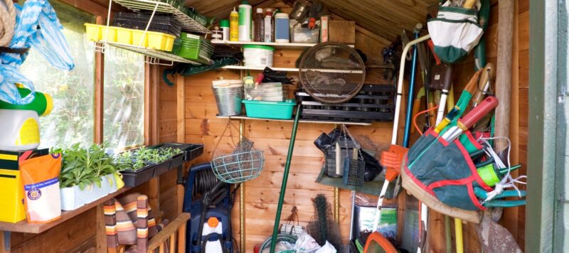 Organized garden shed with tools, pots, and gardening supplies